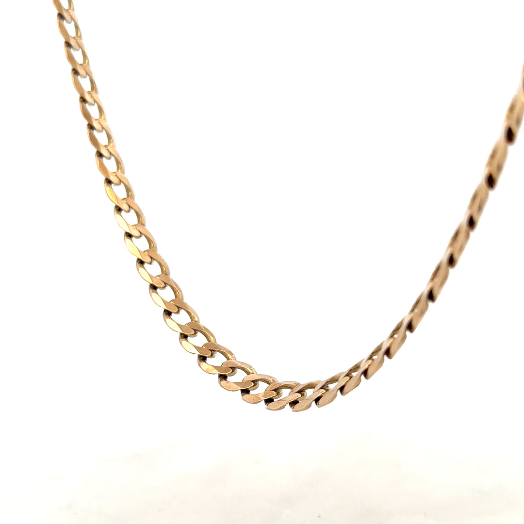 9ct yellow gold curb chain weighing 38.8g, displayed on a neutral background showcasing its links and craftsmanship.