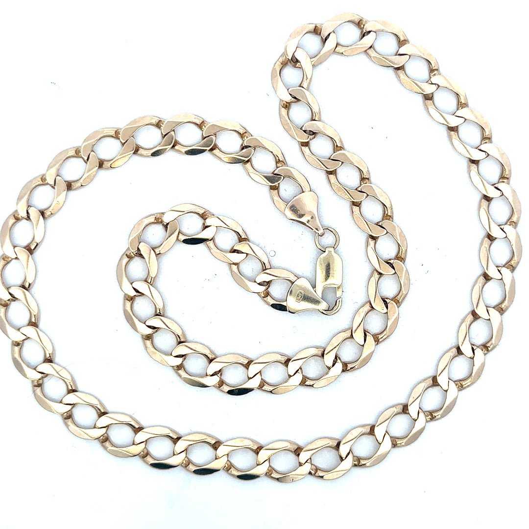 9ct yellow gold curb chain weighing 53.9g, unbranded jewelry with a classic link design, shown in close-up.