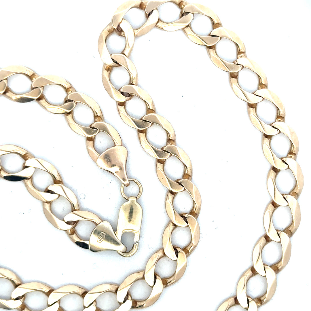 9ct yellow gold curb chain weighing 53.9g, unbranded jewelry with a classic link design, shown in a close-up view.