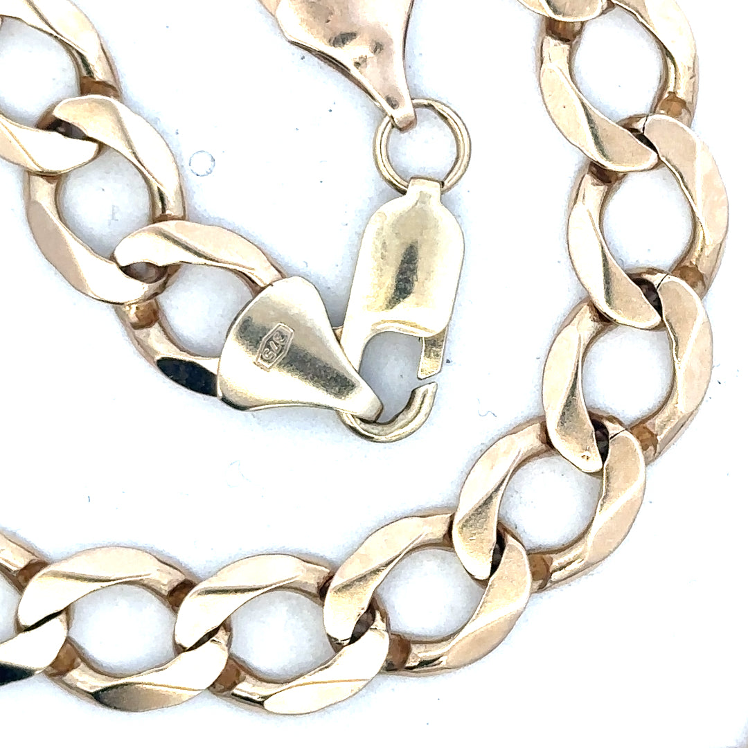 9ct yellow gold curb chain weighing 53.9g, unbranded jewelry with a classic linked design.