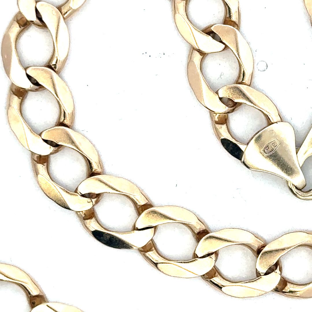 9ct yellow gold curb chain weighing 53.9g, featuring a classic linked design, unbranded jewelry accessory on a plain background.