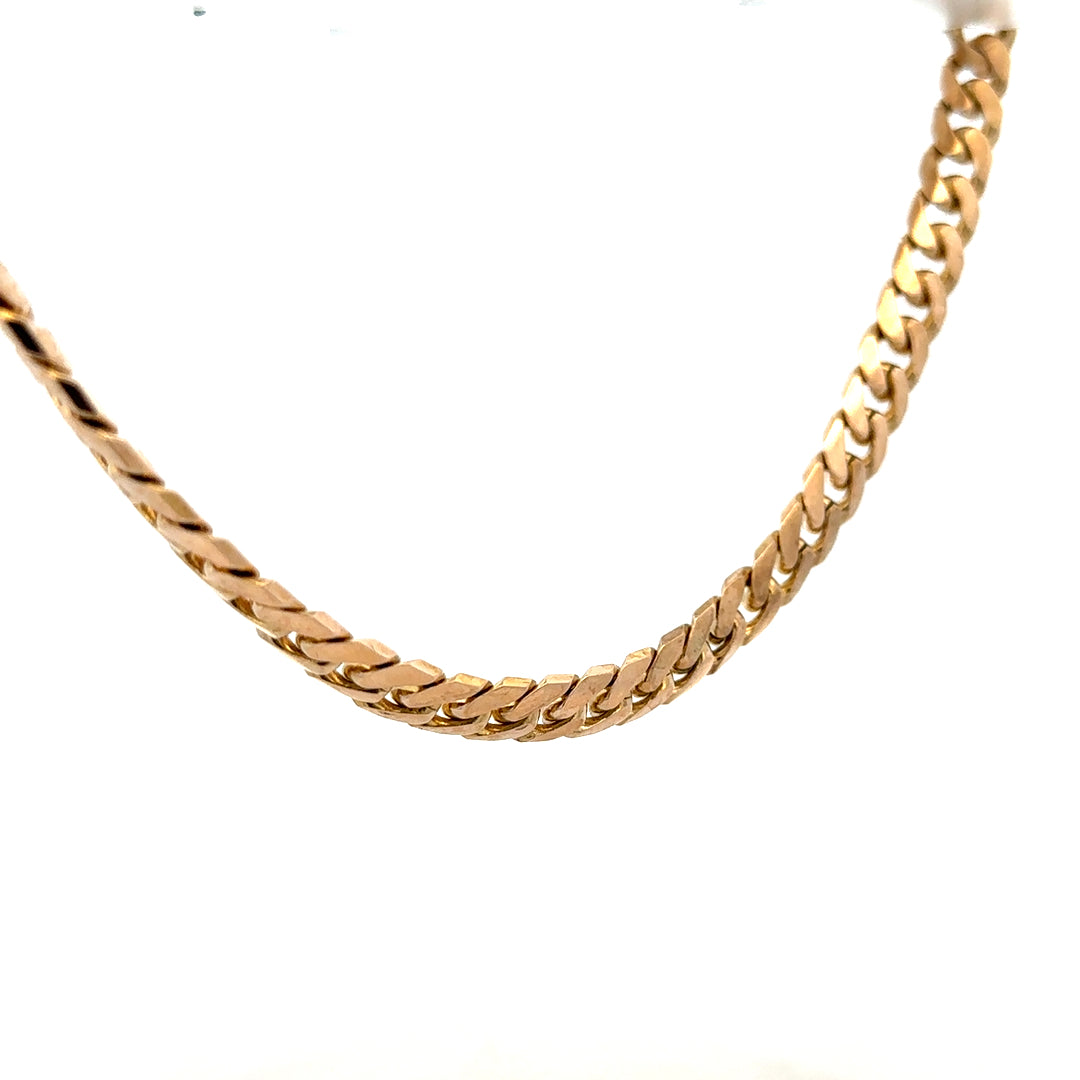 9ct yellow gold curb chain weighing 61.4g, featuring classic interlinked design, unbranded jewelry piece.