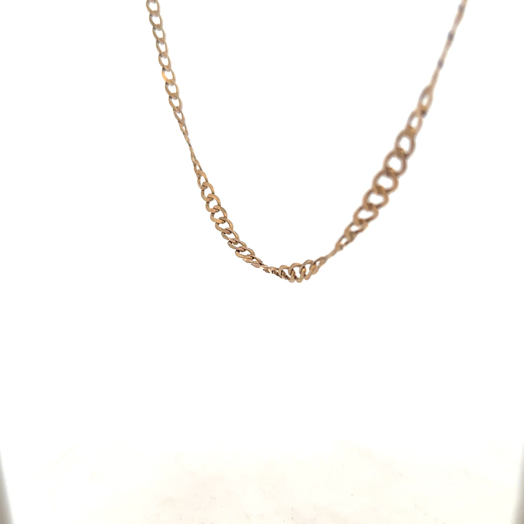 9ct yellow gold curb chain weighing 8.5g, featuring a classic linked design, shown in close-up detail.
