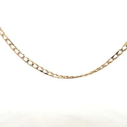 9ct yellow gold curb chain weighing 9.9g, featuring a classic link design, shown in a close-up image highlighting its polished surface.
