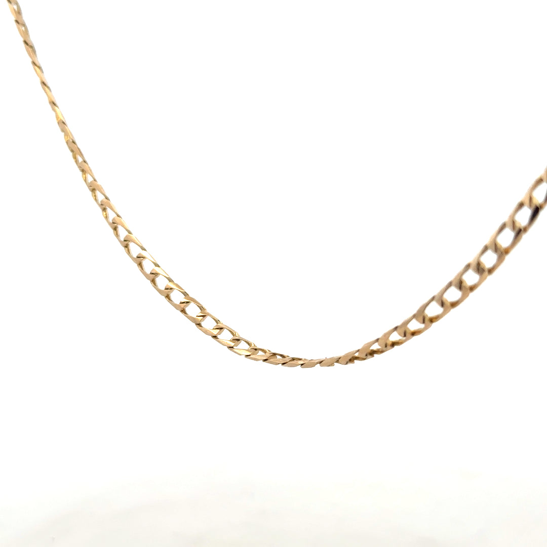 9ct yellow gold curb chain weighing 9.9g, unbranded jewelry with a classic linked design, displayed on a neutral background.