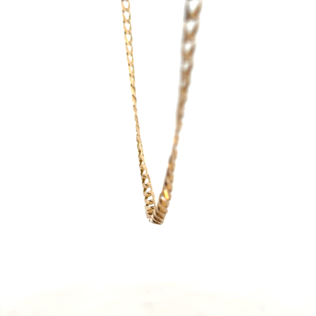 9ct yellow gold curb chain weighing 9.9g, featuring classic links and polished finish, displayed on a neutral background.