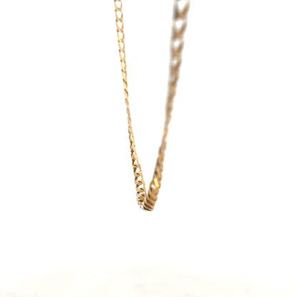 9ct yellow gold curb chain weighing 9.9g, featuring classic links and polished finish, displayed on a neutral background.