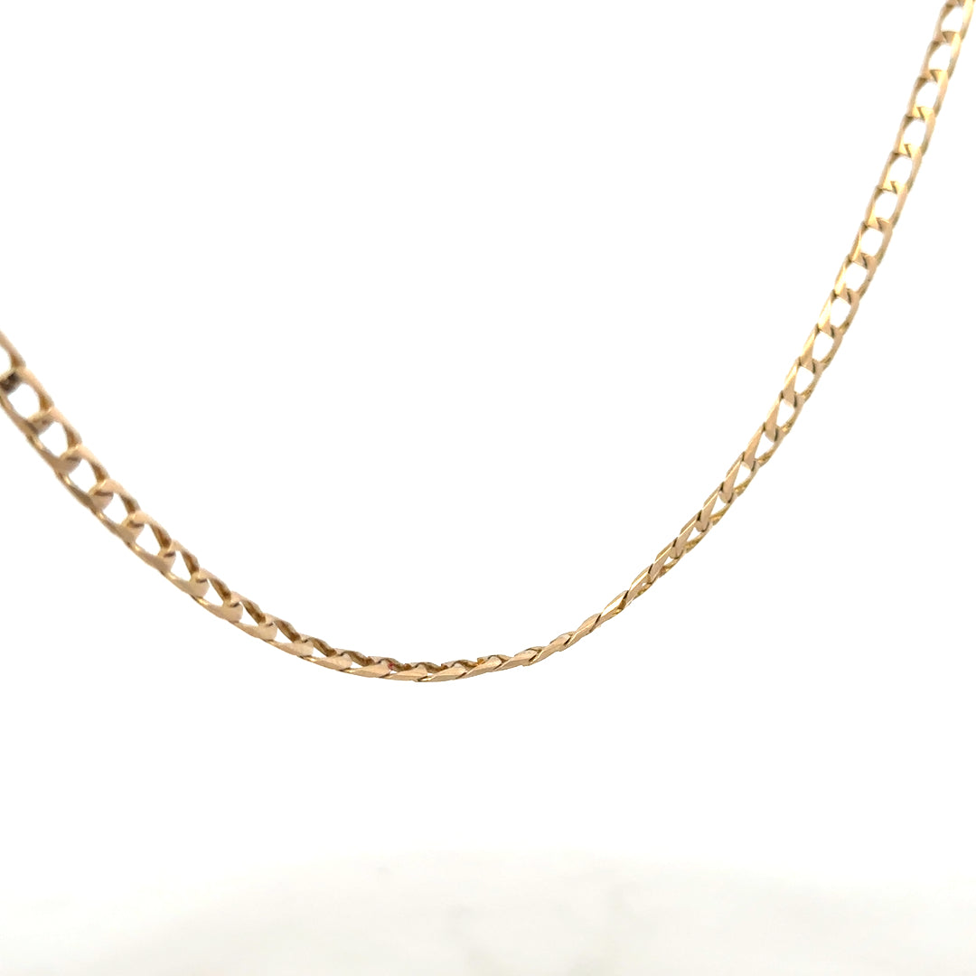 9ct yellow gold curb chain weighing 9.9g, displayed on a plain background, showcasing its classic linked design.
