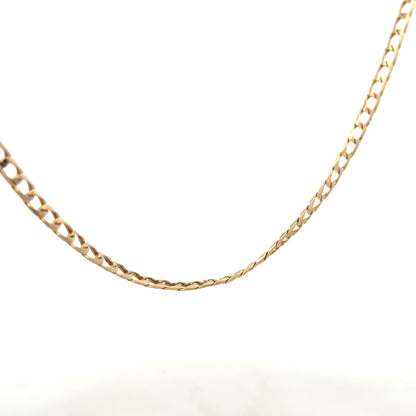 9ct yellow gold curb chain weighing 9.9g, displayed on a plain background, showcasing its classic linked design.