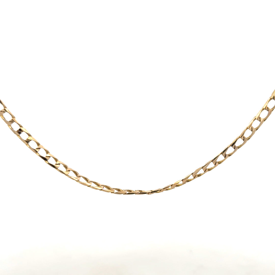 9ct yellow gold curb chain weighing 9.9g, featuring classic interlocking links, unbranded jewelry accessory.