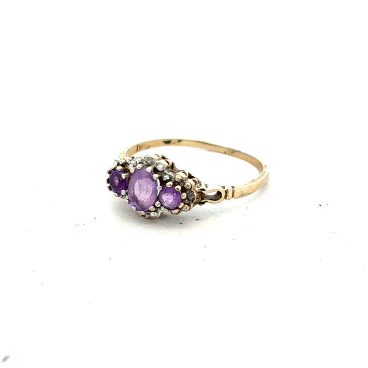 9ct yellow gold ring featuring diamonds and amethyst gemstones, size Q, with intricate band details.