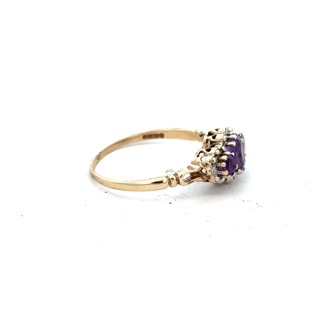 9ct yellow gold ring with diamond and amethyst gemstones, size Q, featuring a detailed band design.