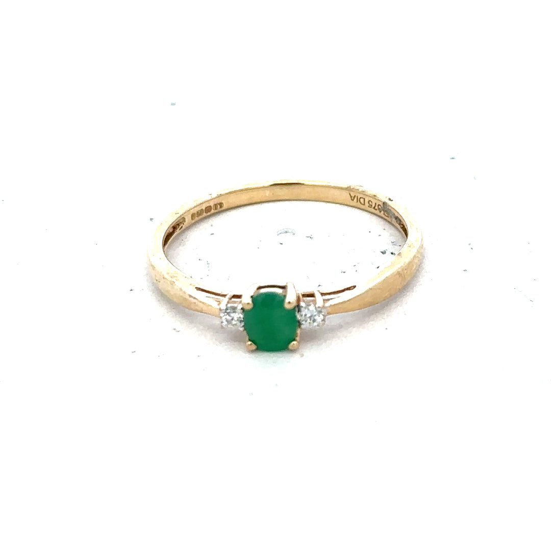 9ct yellow gold diamond and emerald ring size S, featuring a central emerald with diamond accents, shown on a white background.