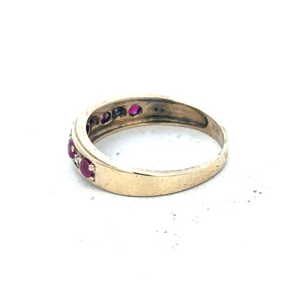 9ct yellow gold diamond and ruby ring with size M, showcasing intricate design and sparkling gemstones on a white background.