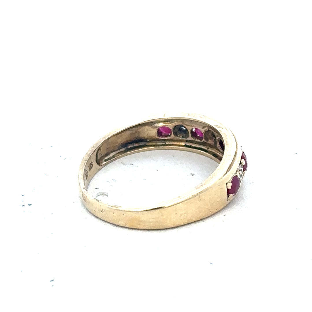 9ct yellow gold diamond and ruby ring, size M, featuring sparkling stones and a delicate band, weighs 2.3 grams.