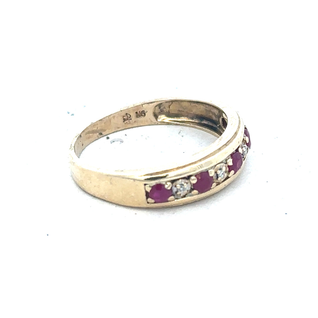 9ct yellow gold ring featuring diamonds and rubies, size M, weighs 2.3g, showcasing a sparkling gemstone design.