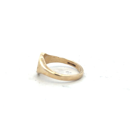 9ct yellow gold diamond ring in size J with a sparkling central diamond, unbranded jewelry, shown from a side angle.