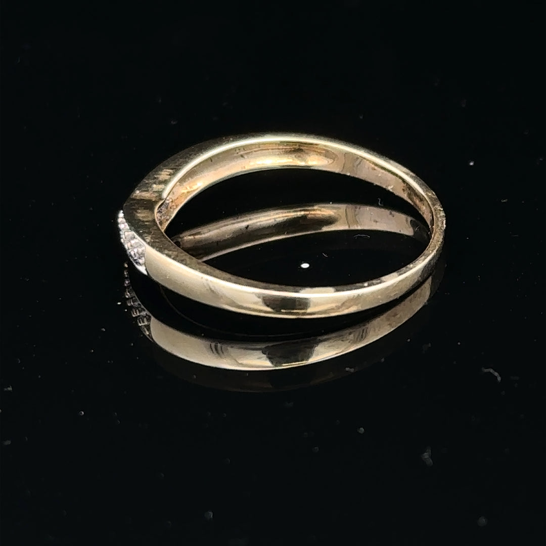 9ct yellow gold diamond ring in size P, showcasing a polished band with a sparkling diamond centerpiece.