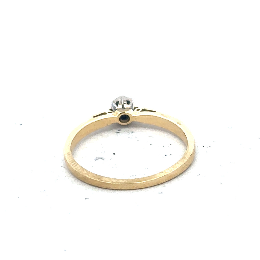 9ct yellow gold diamond solitaire ring with a prominent central gemstone and a sleek band design.