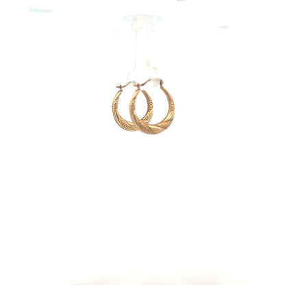 9ct yellow gold earrings weighing 0.8g, featuring a classic design, displayed in a natural pose.