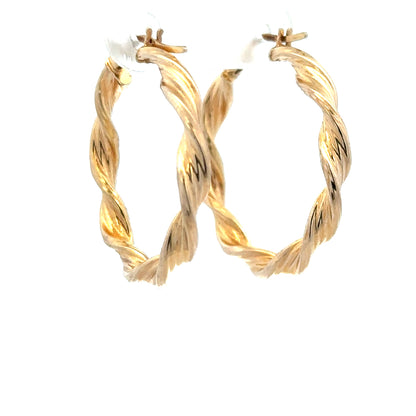 9ct yellow gold earrings weighing 1.6g, featuring a simple and elegant design, shown on a neutral background.
