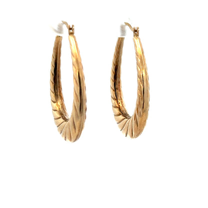 9ct yellow gold earrings weighing 1.6g, featuring a simple and elegant design, displayed in a close-up shot.