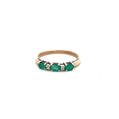 9ct yellow gold emerald and diamond ring in size T, featuring a central emerald surrounded by small diamonds.