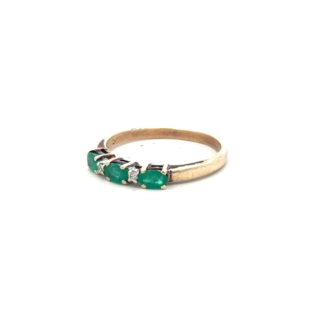 9ct yellow gold emerald and diamond ring in size T, featuring a central emerald and sparkling diamonds on an unbranded band.