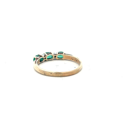 9ct yellow gold emerald and diamond ring in size T, featuring a central emerald gemstone with accent diamonds.