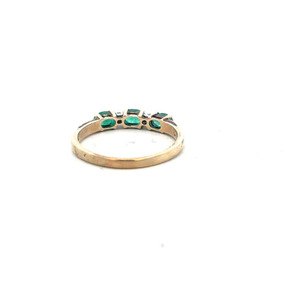 9ct yellow gold emerald and diamond ring in size T, featuring a central emerald and sparkling diamonds on a delicate band.