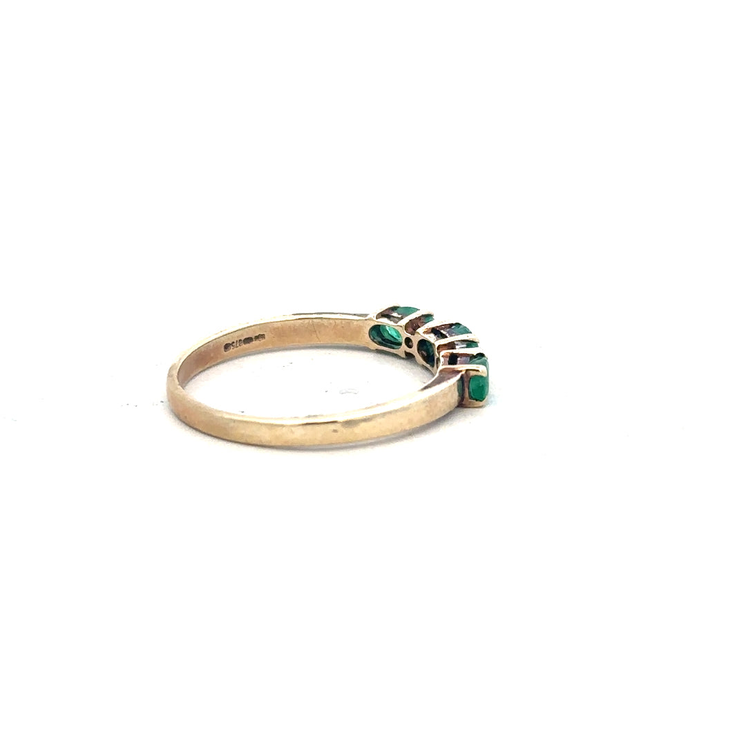 Yellow gold emerald and diamond ring in size T, featuring a 9ct gold band with sparkling gemstones.
