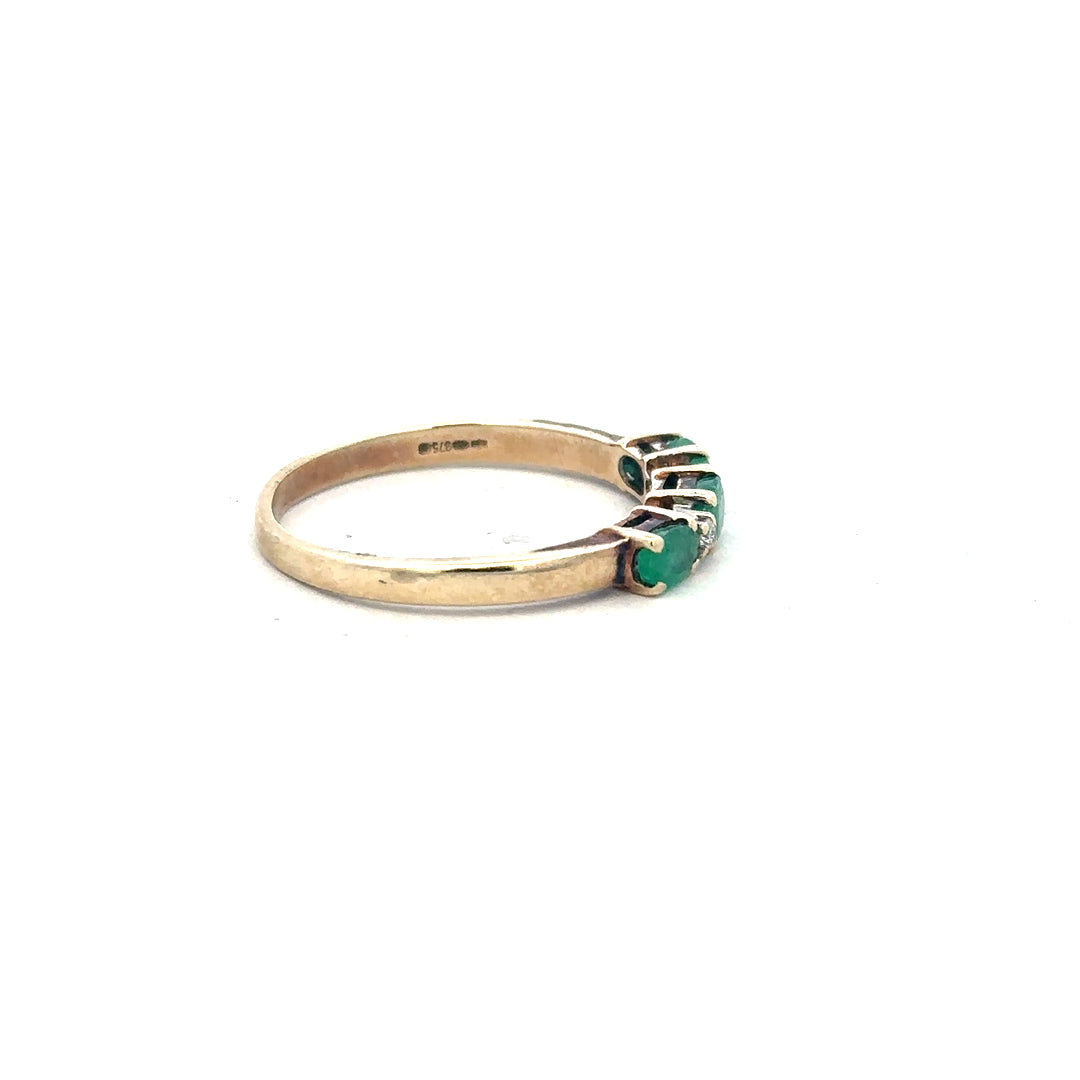 9ct yellow gold emerald and diamond ring in size T, featuring a central emerald gemstone with diamond accents.