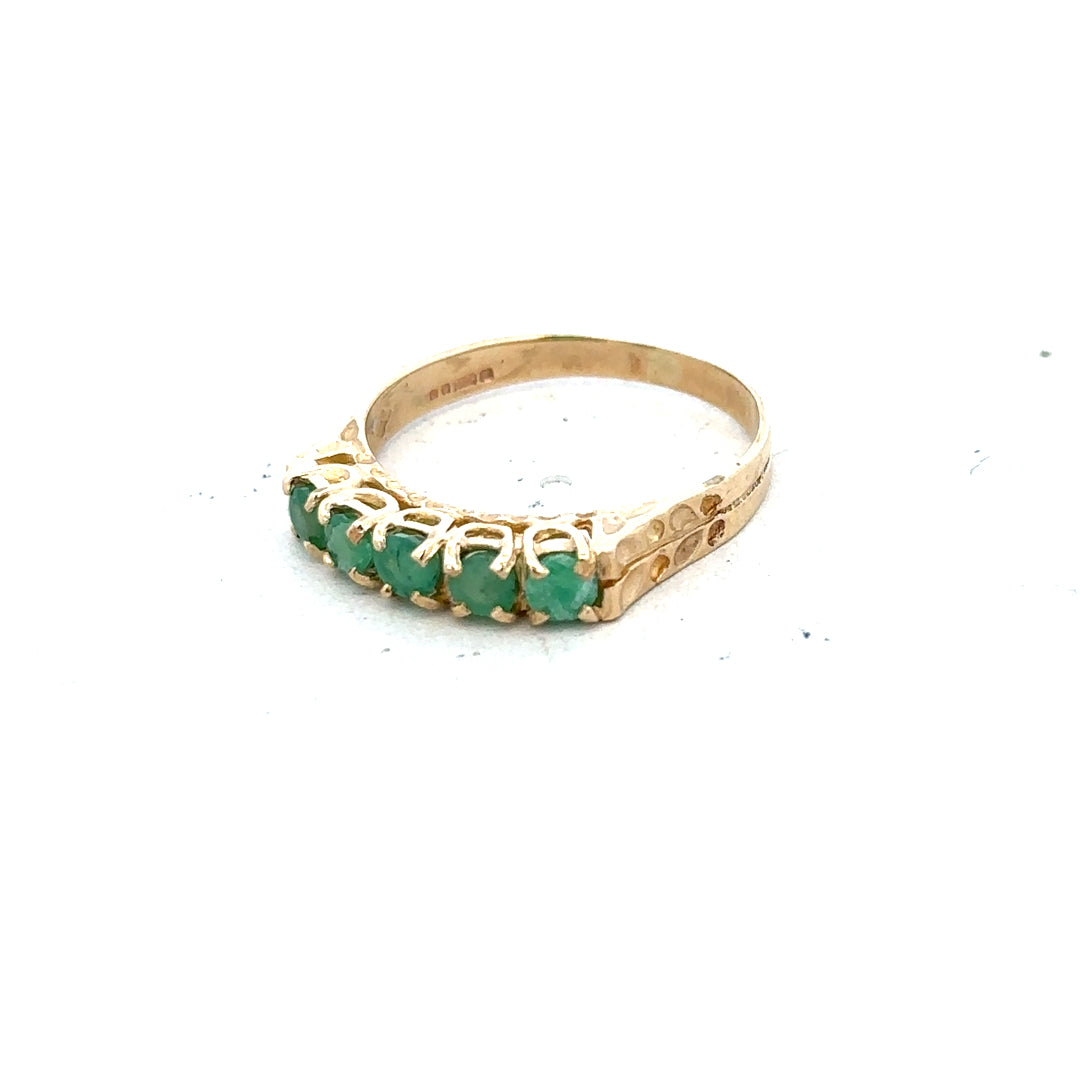 9ct yellow gold emerald ring size P featuring a vibrant emerald gemstone set in a classic gold band.