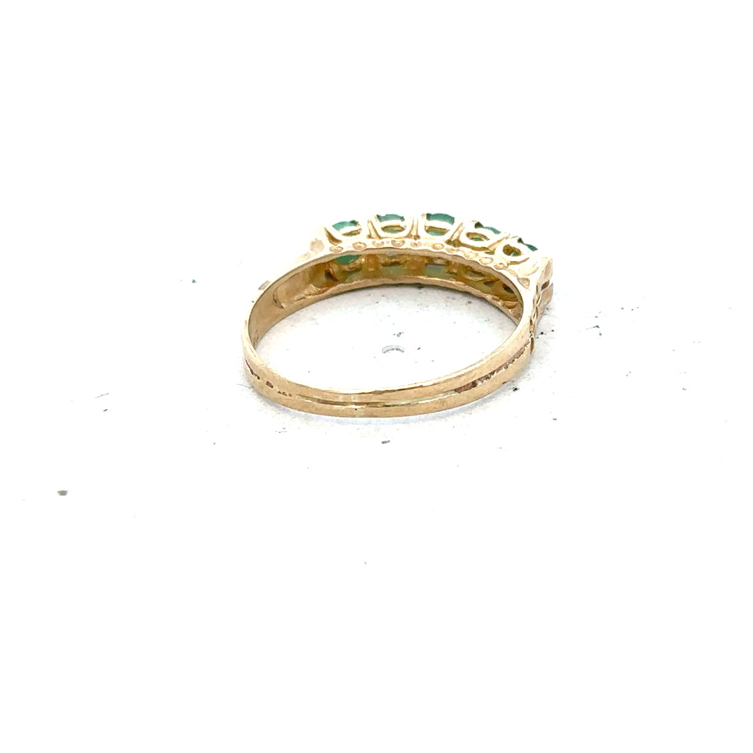 9ct yellow gold emerald ring in size P with a central emerald gemstone, unbranded jewelry displayed on a neutral background.