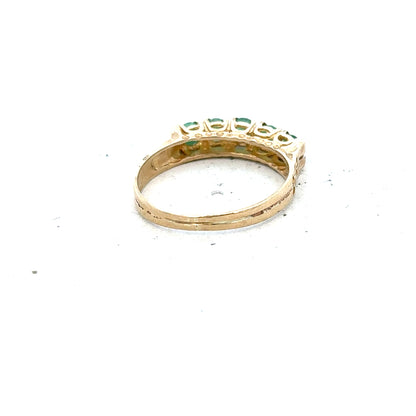 9ct yellow gold emerald ring in size P with a central emerald gemstone, unbranded jewelry displayed on a neutral background.