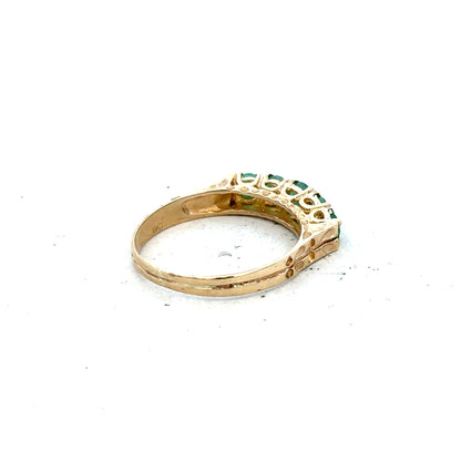 9ct yellow gold emerald ring in size P with a central emerald gemstone, featuring a simple elegant design.