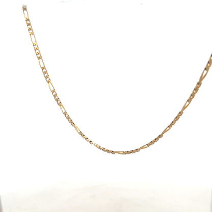 9ct yellow gold figaro chain weighing 7.2g, unbranded jewelry with intricate linked design, displayed against a neutral background.
