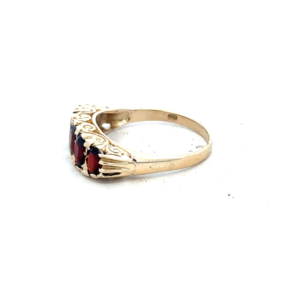 9ct yellow gold garnet ring in size S with a polished gold band and a deep red garnet gemstone.