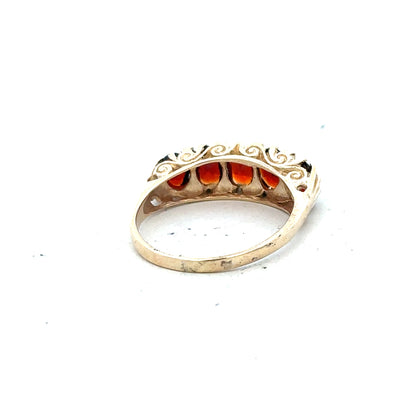 9ct yellow gold garnet ring in size S, featuring a vibrant red garnet gemstone set in a polished gold band.