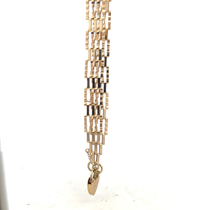 9ct yellow gold gate bracelet with a sleek chain design, weighing 5.8g, featuring polished gold links.