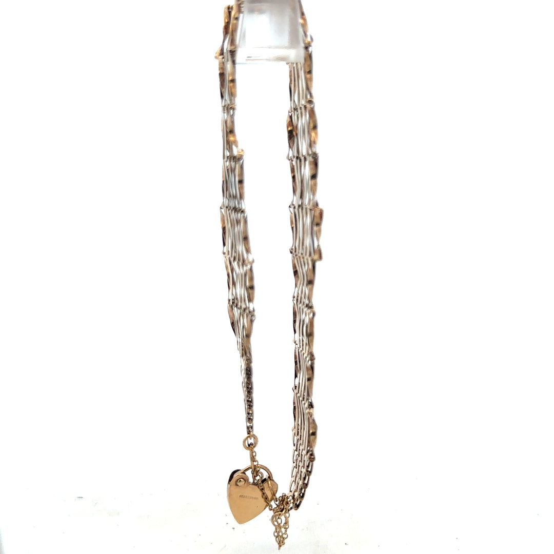 9ct yellow gold gate bracelet weighing 7.4g, featuring classic linked design, unbranded jewelry accessory in this detailed image.