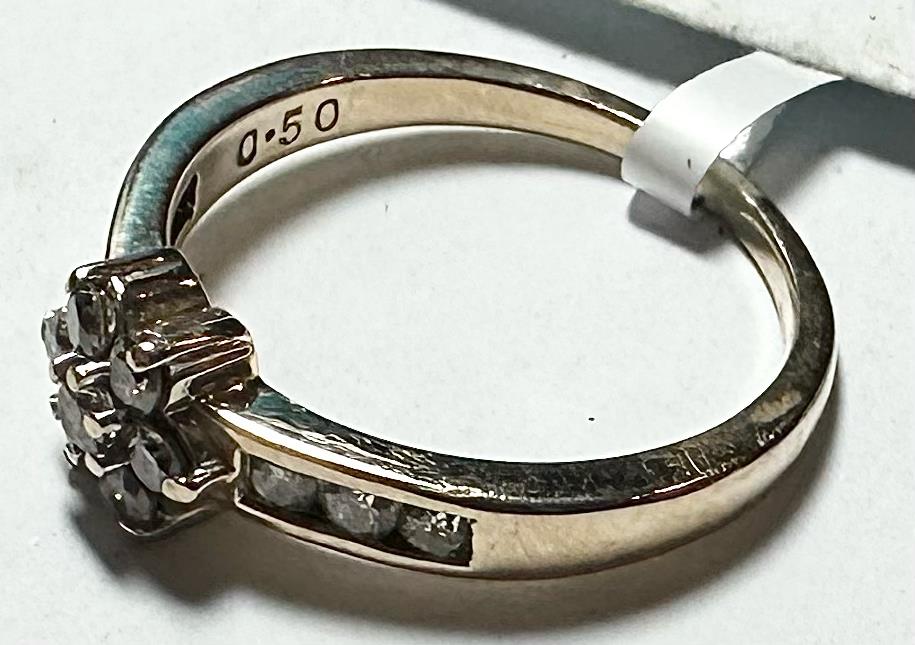 9ct yellow gold half-caret diamond ring in size M, featuring a sparkling diamond centerpiece and a sleek band.