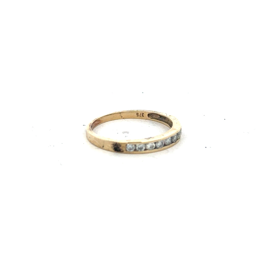 9ct yellow gold half eternity diamond ring in size N, featuring a row of sparkling diamonds set in a gold band.