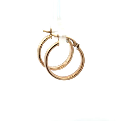 9ct yellow gold hoop earrings weighing 1.1g, stylish jewelry accessory with a classic hoop design in warm gold tone.
