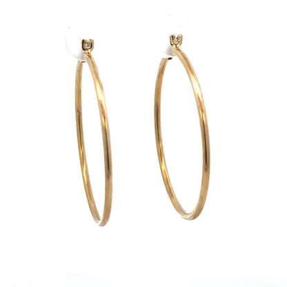 9ct yellow gold hoop earrings, lightweight 1.1g, classic round design, unbranded jewelry accessory with shiny finish.