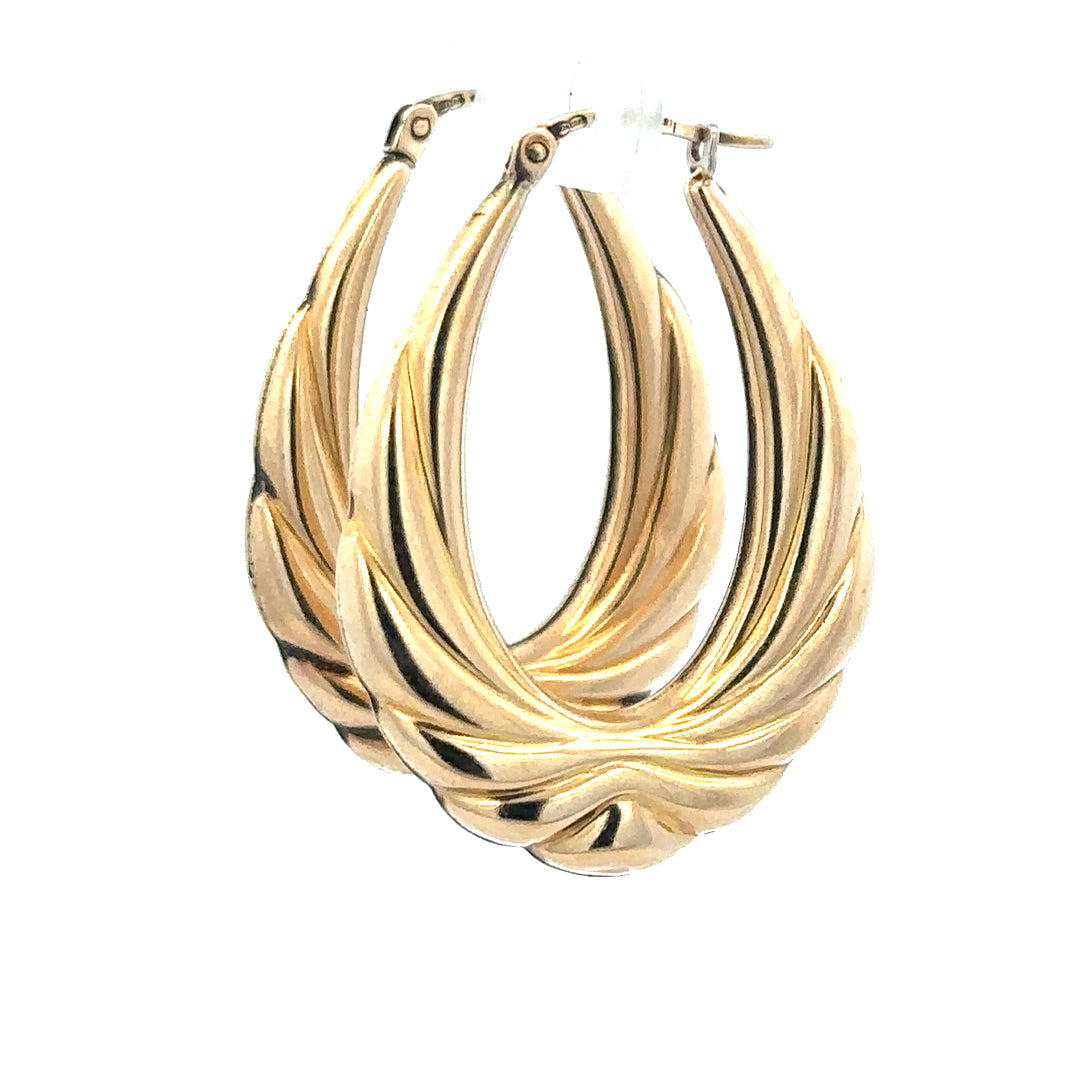 9ct yellow gold hoop earrings weighing 3.8g, unbranded, shown in a close-up image highlighting their smooth, classic hoop design.