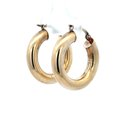 9ct yellow gold hoop earrings weighing 3.9g, unbranded, with a smooth circular design and polished finish.