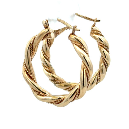 9ct yellow gold hoop earrings, unbranded, 4.9g, shiny and smooth round hoops shown in a close-up image.
