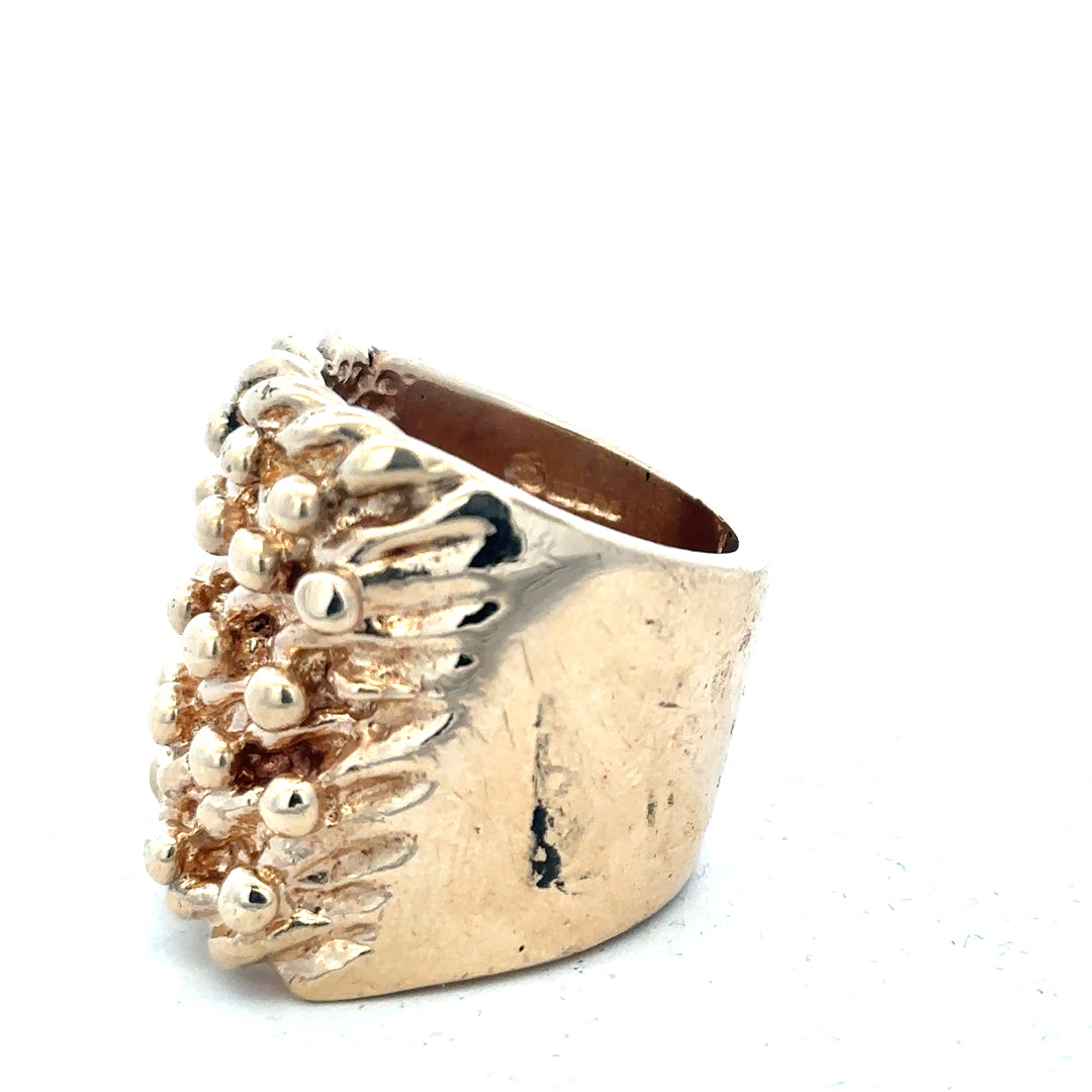 9ct yellow gold keeper ring weighing 61.1g, unbranded, with intricate design and polished finish, shown in close-up view.