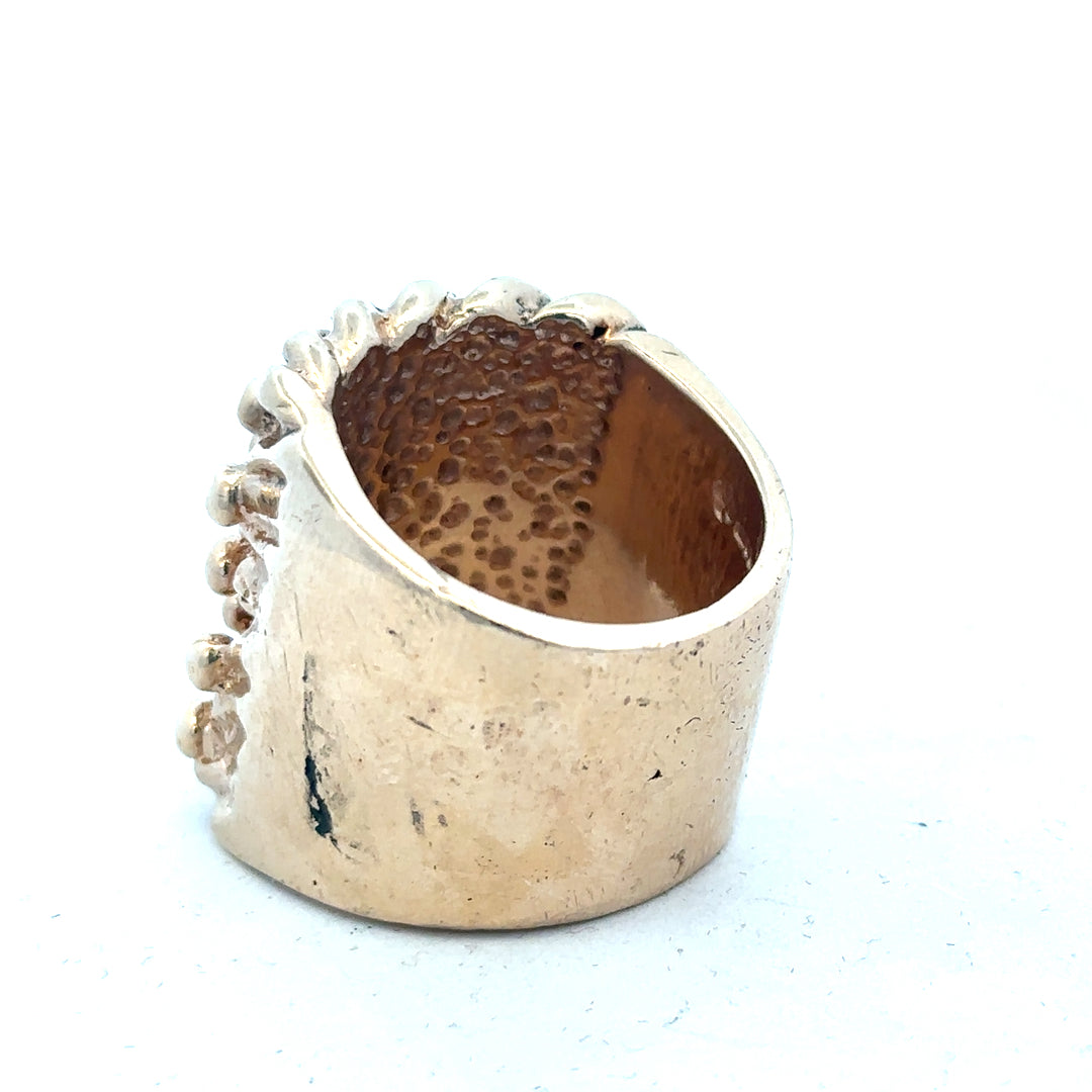 9ct yellow gold keeper ring, unbranded, showing the polished band and detailed craftsmanship in a close-up image.